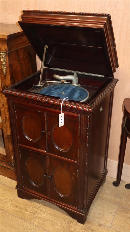 A 1930s gramophone, contained in a carved mahogany cabinet (top split)